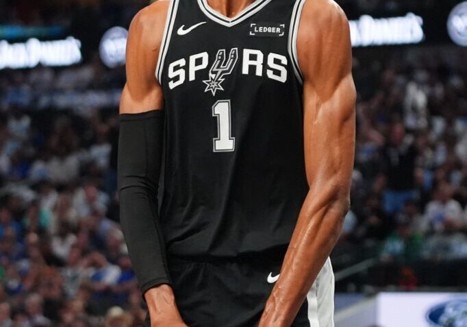 San Antonio Spurs forward Victor Wembanyama reacts to a play during the first half of an NBA basketball game against the Dallas Mavericks in Dallas, Wednesday, Oct. 22, 2025. (AP Photo/LM Otero)